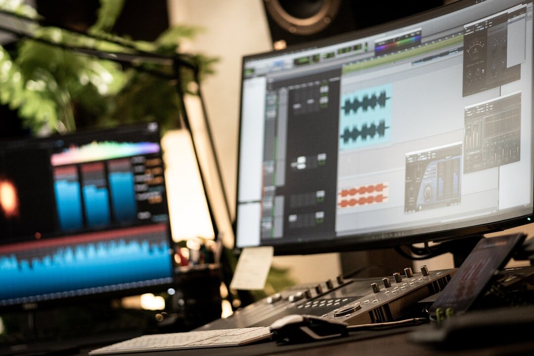 Professional video editing workstation with multiple monitors showing editing software