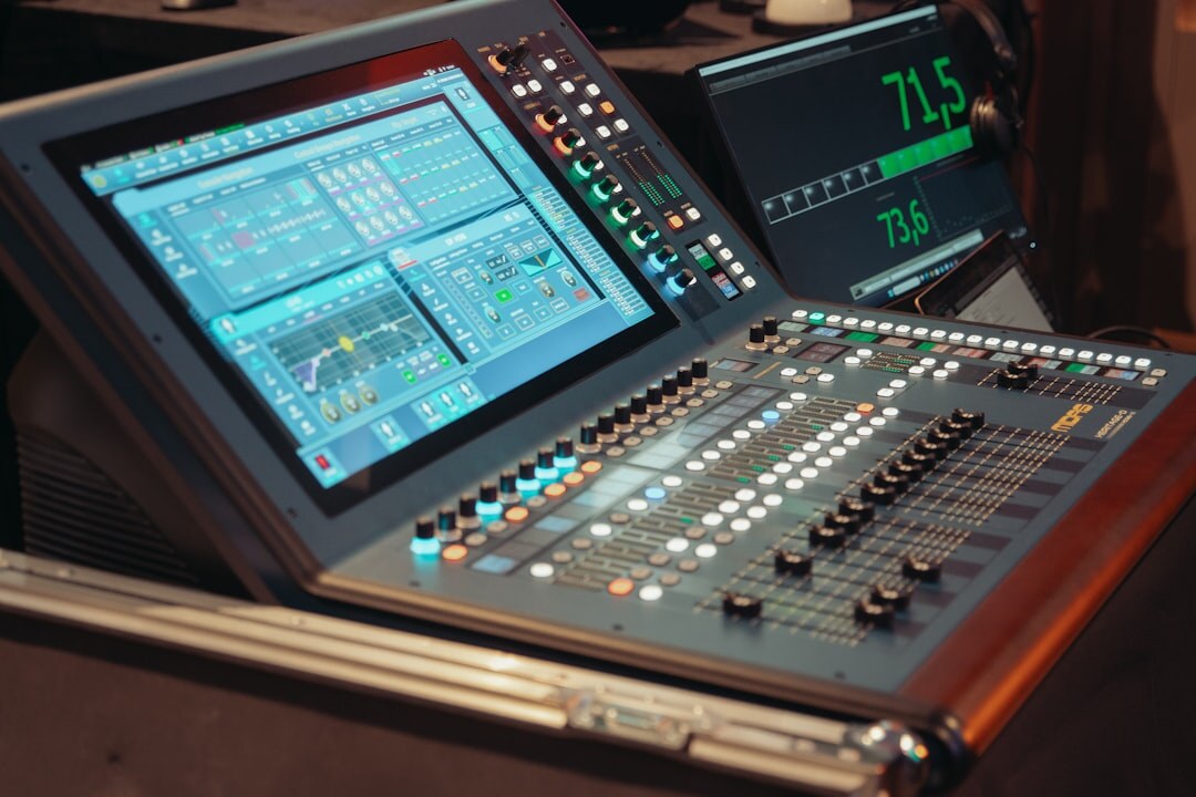 TV news anchor at broadcast desk in modern studio with screens in background