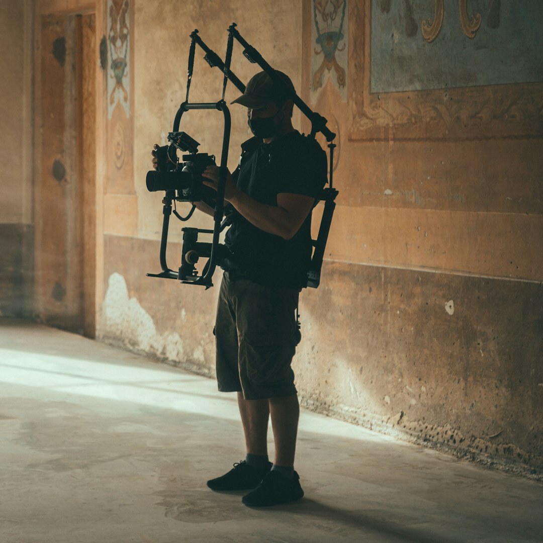 Young Turkish man smiling with a camera in hand