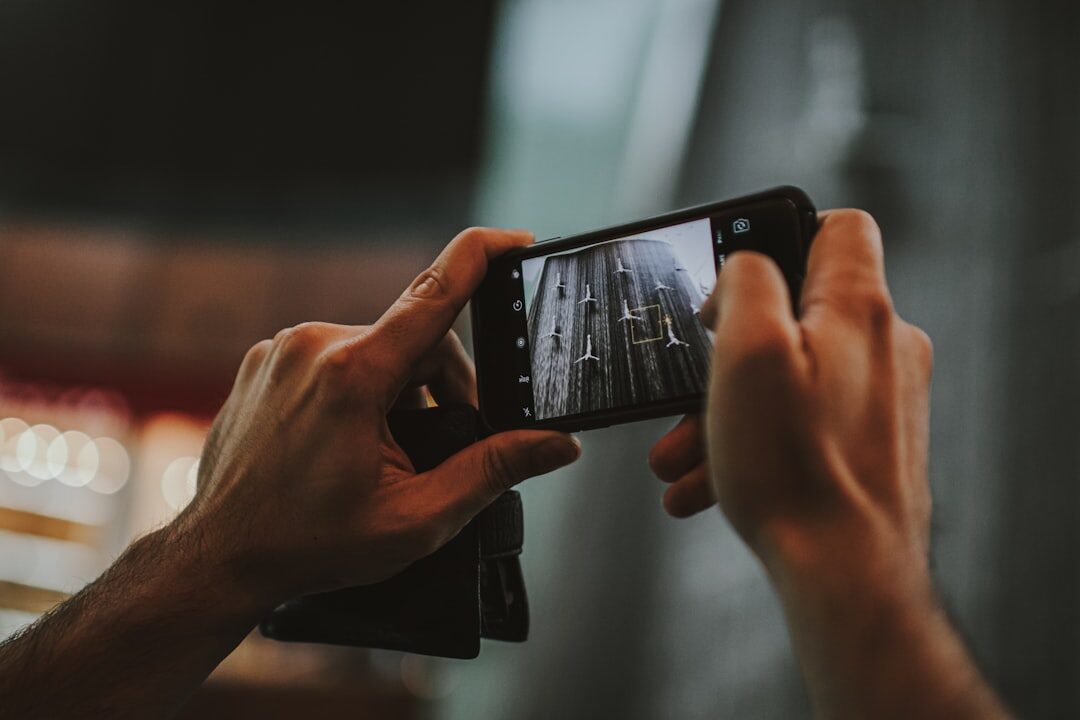 Person holding smartphone filming video content for digital media