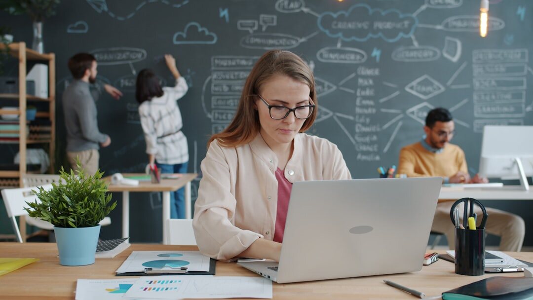 Turkish woman working on laptop in a bright modern coworking space
